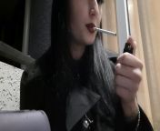 Dominatrix Nika smokes a cigarette on the balcony. Mistress sexy red lips blow smoke in your face from red lips blowbing