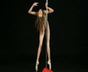 Gorgeous nude ballerina Annett A dances on a pole. Girl dancer spreads her flexible long legs wide from nude lady with long legs enjoys standing doggy